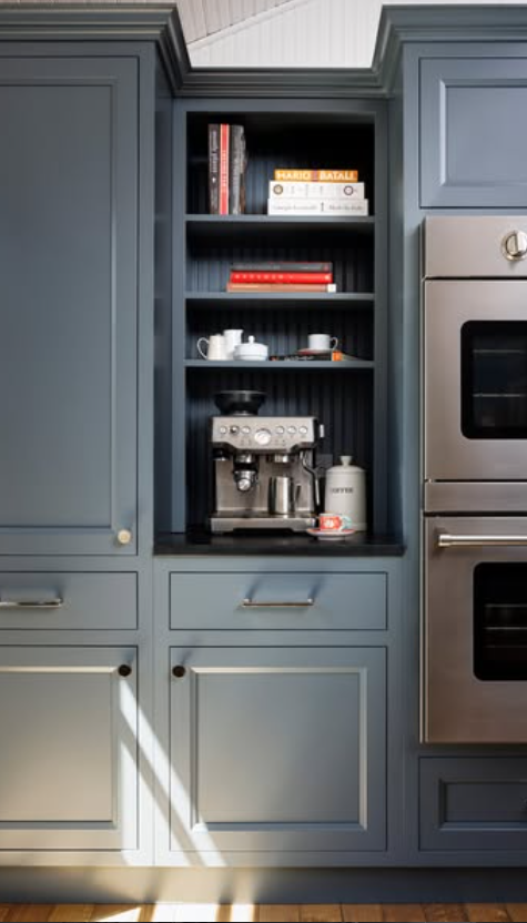 Navy blue built-in cabinet with  shelving for coffee station storage