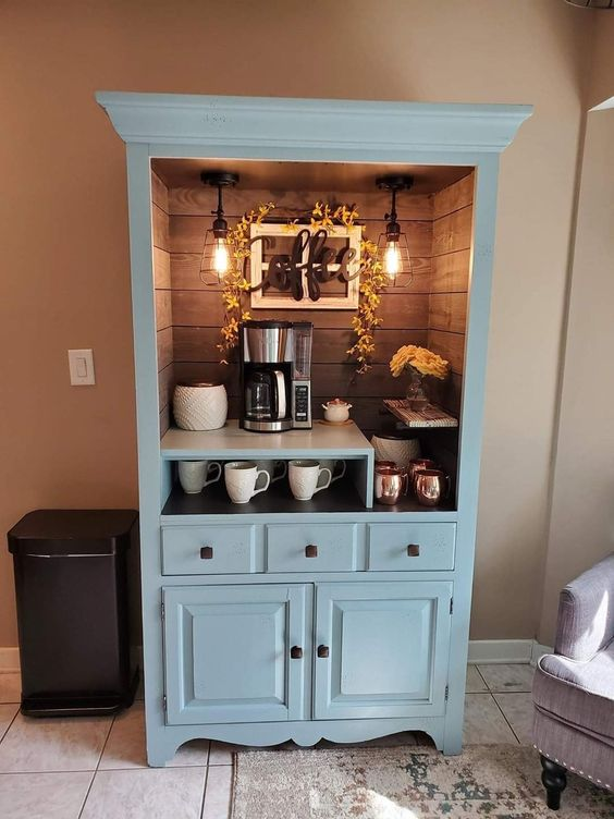 Repurposed light blue hutch converted to freestanding coffee bar with interior lighting