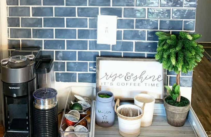 Blue subway tile backsplash with white grout, wooden tray, and Nespresso coffee setup