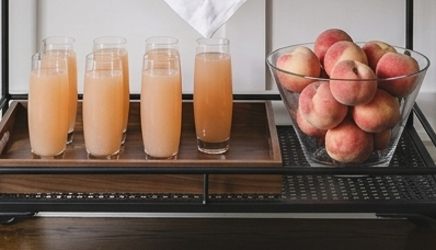 bellinis with a bowl of peaches on a shelf
